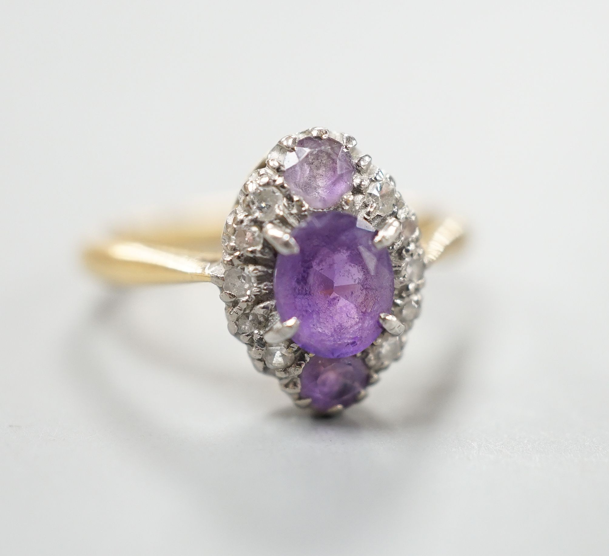 An early 20th century 18ct & plat, amethyst and diamond set marquise cluster ring, size K, gross weight 3.2 grams.